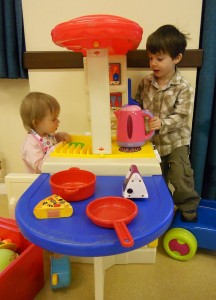 Two babies playing with toys