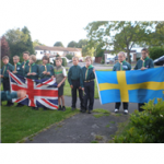 A group of kids holding up a British and Swedish flag 