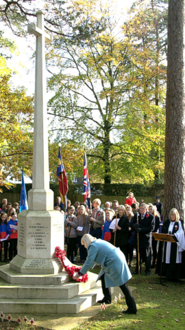 The Chairman of the Parish Council laying a wreath at the War Memorial