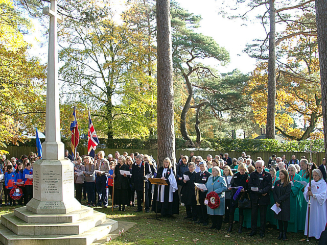 A group of people around the war memorial in Colehill, Dorset